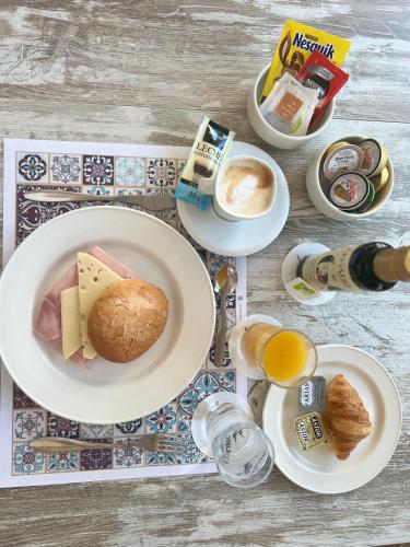 a table with a plate of food and coffee and eggs at Hotel Rural Cazorla Posada del Cordobés in Cazorla
