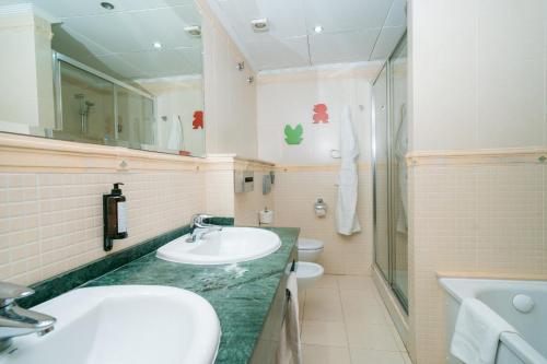 ein Badezimmer mit einem Waschbecken und 2 WCs in der Unterkunft Hotel Magic Games 4 in Oropesa del Mar