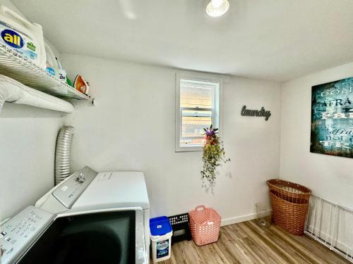 a kitchen with a microwave and a window at Cozy Private Room with Shared Bathroom on the 1st Floor - Conveniently Located near SeaTac Airport and Downtown in Seattle