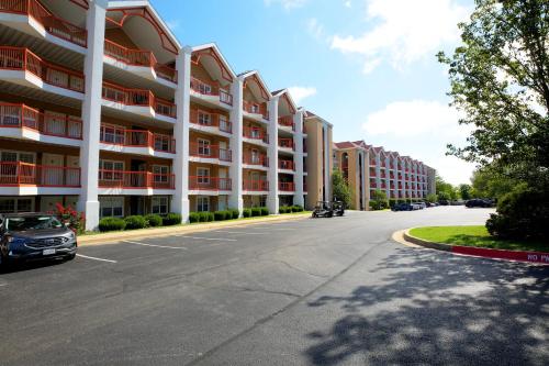 an empty street in front of a large apartment building at Grand Crowne Resort by Capital Vacations in Branson