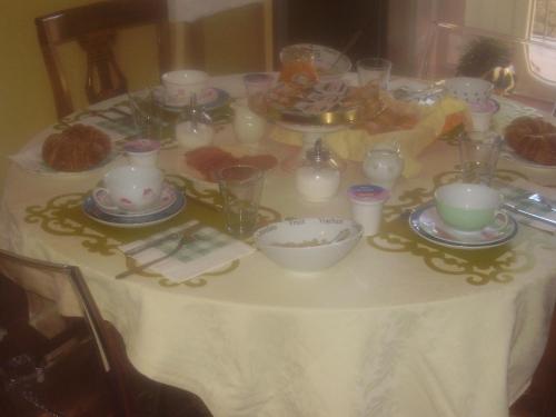 een tafel met een witte tafeldoek met kaarsen erop bij B&B Gens Julia in Trieste