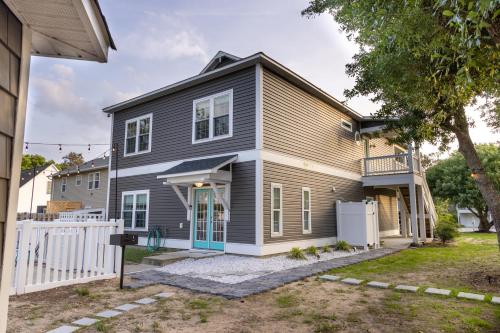 a gray house with a white fence at Voyage Anchor in Nags Head