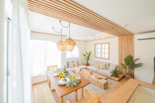 a living room with a table and a couch at Lawsoon in Uruma