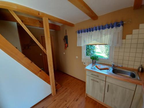 a kitchen with a sink and a counter top at Ferienhaus zur Dorfbachklamm in Altendorf