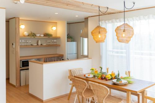 a kitchen and dining room with a table and chairs at Lawsoon in Uruma