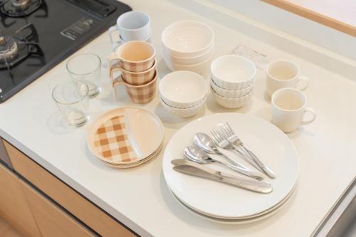 a table with plates and utensils on a counter at Lawsoon in Uruma