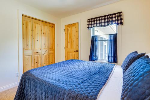 a bedroom with a blue bed and a window at Lakefront Vacation Rental about 10 Mi to Shipshewana! in Howe