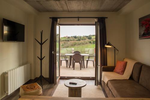 a living room with a couch and a table at Apartamentos Estela de Altamira in Santillana del Mar