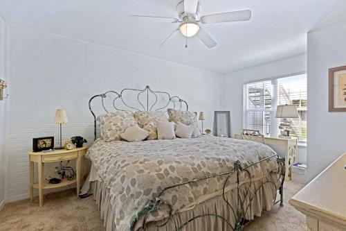a bedroom with a bed and a ceiling fan at Beachside Elegance: Pool Spa Luxury Retreat Sun Beach Club 888 in Edgewater