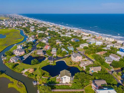 an aerial view of a resort complex next to the ocean at Just Another Day in Paradise in Surf City