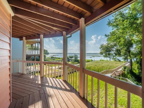 a deck with a view of the water at Just Another Day in Paradise in Surf City