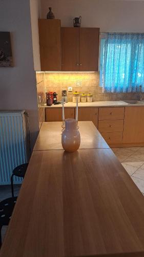 a vase sitting on a wooden table in a kitchen at Panorama View Aigio in Aígio