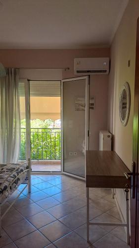 a room with a bed and a sliding glass door at Panorama View Aigio in Aígio