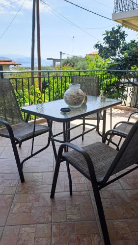a table and two chairs on a patio at Panorama View Aigio in Aígio