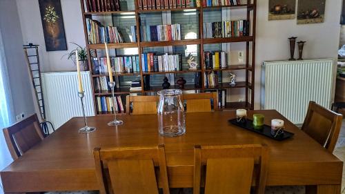 a dining room table with a vase on top of it at Panorama View Aigio in Aígio