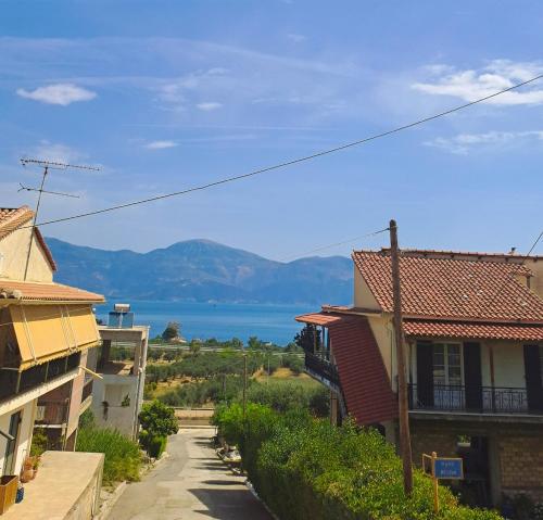 a view of the water from between two buildings at Panorama View Aigio in Aígio