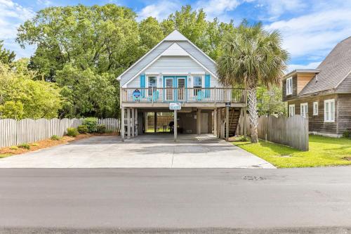 a house with a balcony on the front of it at Just Beachy Spartanburg in Carolina Beach