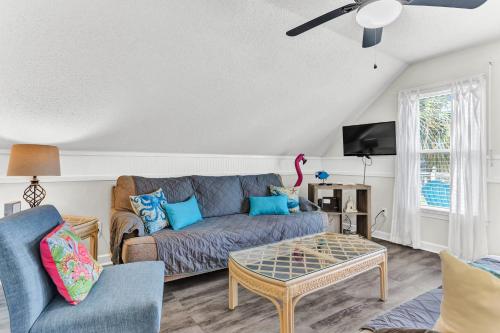 a living room with a couch and a table at Just Beachy Spartanburg in Carolina Beach