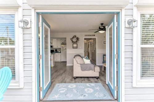 a door leading into a living room with a couch at Just Beachy Spartanburg in Carolina Beach