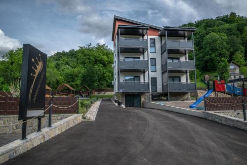 an apartment building with a playground next to a street at Japods Kingdom in Bihać