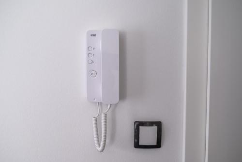 a white phone is hanging on a wall at Japods Kingdom in Bihać