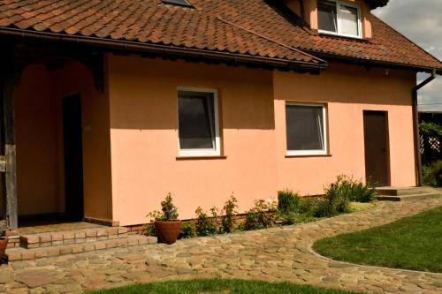 a house with a red roof at Noclegi Tomaszkowo in Tomaszkowo