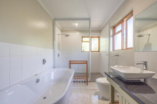 a bathroom with a tub and a sink and a toilet at 1-on-Ross in Grahamstown