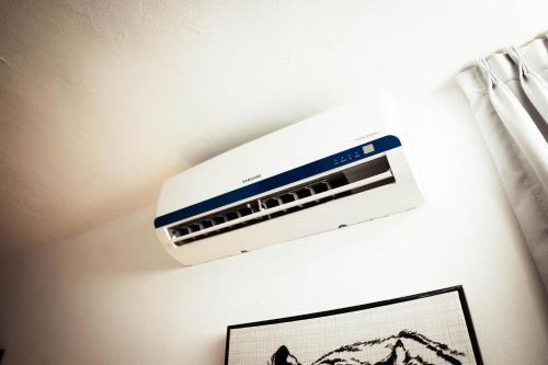 a air conditioner is hanging on a wall at Residenciales H1 & H2 - Breakfast & Room Service - Airport close in Santiago de los Caballeros
