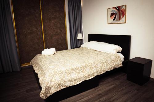a hotel room with a bed with two pillows at Residenciales H1 & H2 - Breakfast & Room Service - Airport close in Santiago de los Caballeros