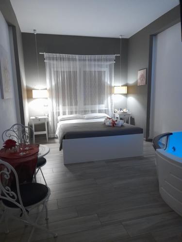 a bedroom with a bed and a tub in it at Il Mare Di Roma Luxury in Lido di Ostia