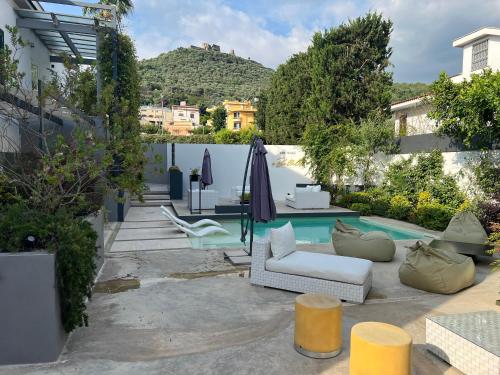 a patio with chairs and a pool in a house at Ghe kalè Resort in San Paolo Bel Sito