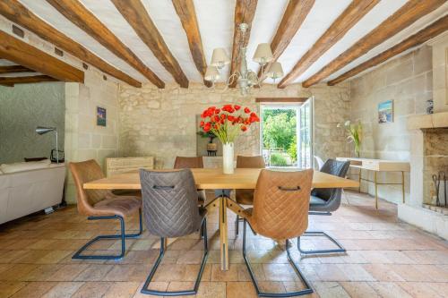 une salle à manger avec une table et des chaises en bois dans l'établissement Longère Spa & Bien-être, à La Chapelle-sur-Loire