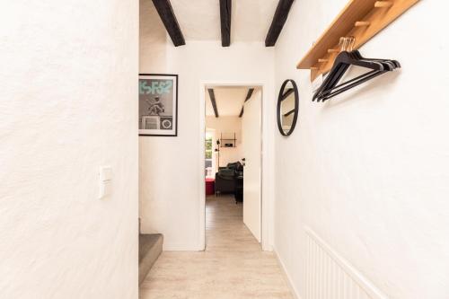 a hallway with white walls and a clock on the wall at Inselkind in Munkmarsch