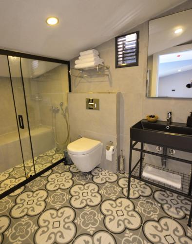 a bathroom with a toilet and a shower and a sink at Ağva Casa Rosa Bungalov Otel in Sile