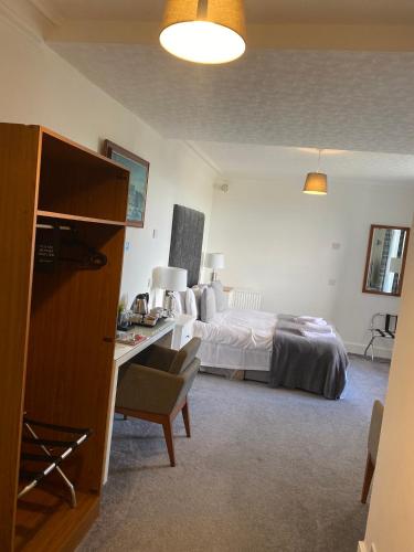 a bedroom with a bed and a desk with a desk at Ellwyn House in Edinburgh