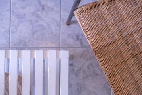 a chair sitting next to a tiled floor at Akroyiali - Guesthouse in Gerolimenas