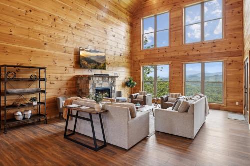 a living room with wooden walls and a fireplace at Oakley Lodge: Luxury Cabin w/ MTN Views Indoor Pool • Hot Tub in Sevierville