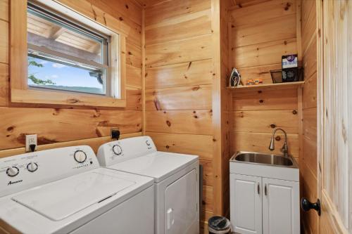 a laundry room with a washer and dryer and a sink at Oakley Lodge: Luxury Cabin w/ MTN Views Indoor Pool • Hot Tub in Sevierville