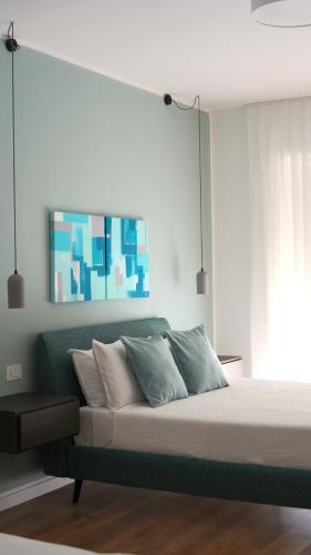 a bedroom with a bed with blue and white pillows at Binario9 in Lecce