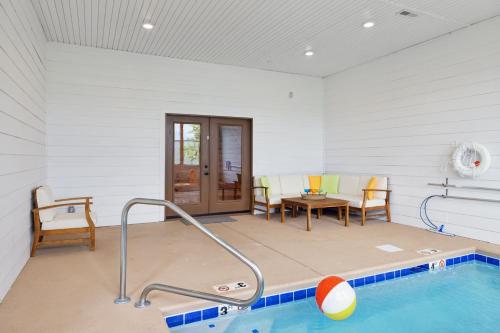 a room with a swimming pool in a house at Oakley Lodge: Luxury Cabin w/ MTN Views Indoor Pool • Hot Tub in Sevierville