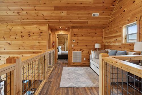 a log cabin living room with wooden walls and wooden floors at Oakley Lodge: Luxury Cabin w/ MTN Views Indoor Pool • Hot Tub in Sevierville
