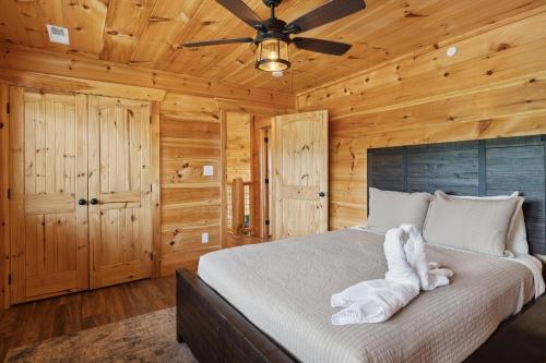 a bedroom with a bed with an elephant made out of towels at Oakley Lodge: Luxury Cabin w/ MTN Views Indoor Pool • Hot Tub in Sevierville