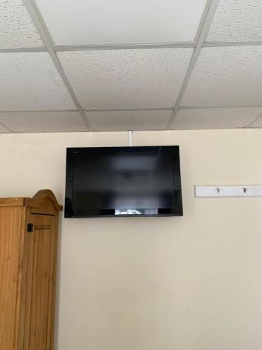 a television hanging on a wall in a room at Clarendon Lodge - accommodation only in Skegness