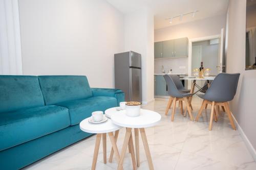 a living room with a blue couch and chairs at Apartment Kjara in Herceg-Novi
