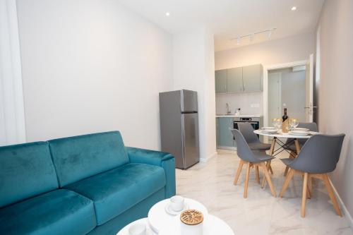a living room with a blue couch and a table at Apartment Kjara in Herceg-Novi
