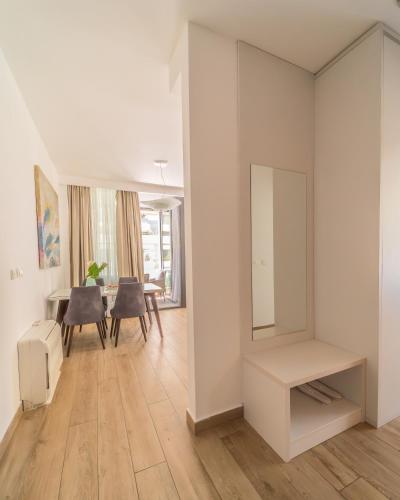 a living room with a table and a mirror at Amare Luxury Apartments in Budva