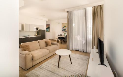 a living room with a couch and a table at Amare Luxury Apartments in Budva