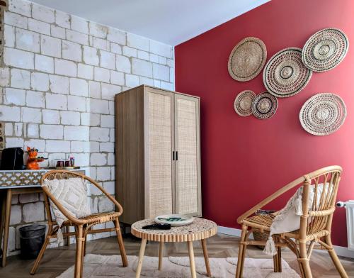 une pièce avec des chaises et une armoire avec des chapeaux au mur dans l'établissement Le Relais du Beffroi & SPA, à Saint-Riquier