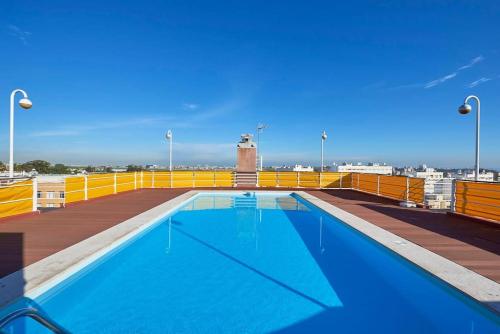 a large swimming pool on the roof of a building at Modern apartment with garage and pool in Lisbon