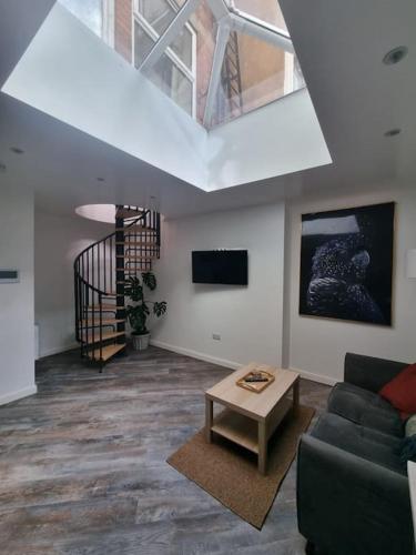 a living room with a couch and a table at New ground floor city centre apartment in Hull